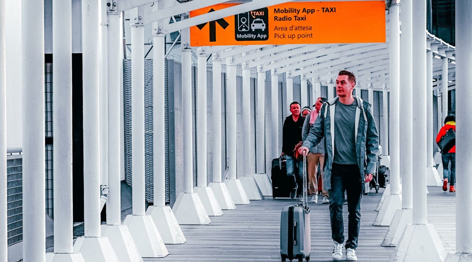 Travellers walking through a modern airport terminal