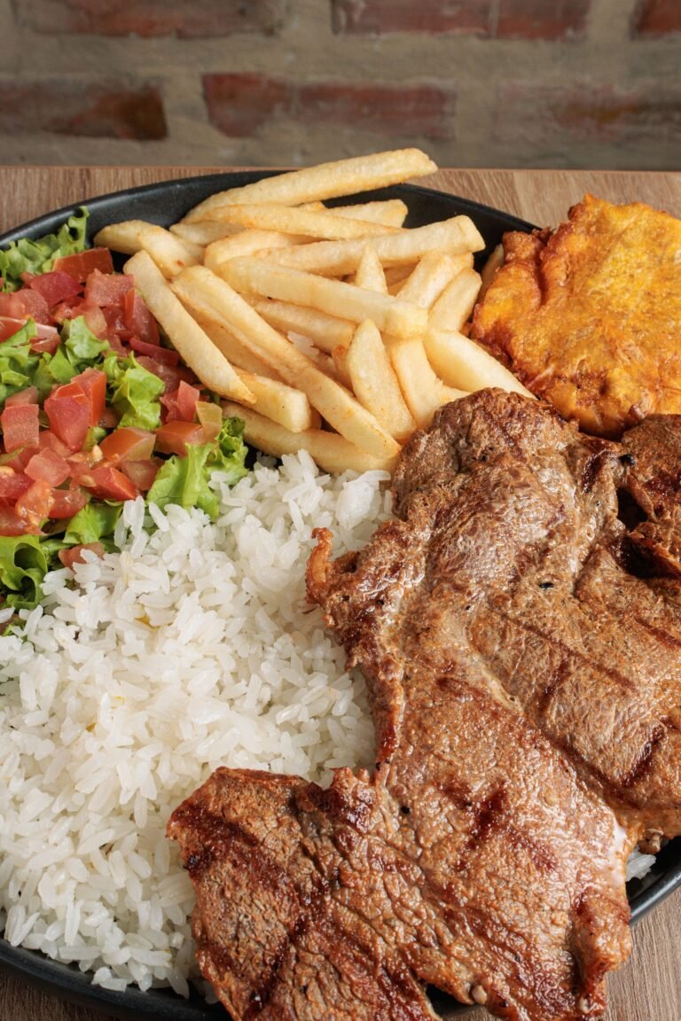 Traditional Colombian bandeja paisa with grilled meat, rice, beans and plantain