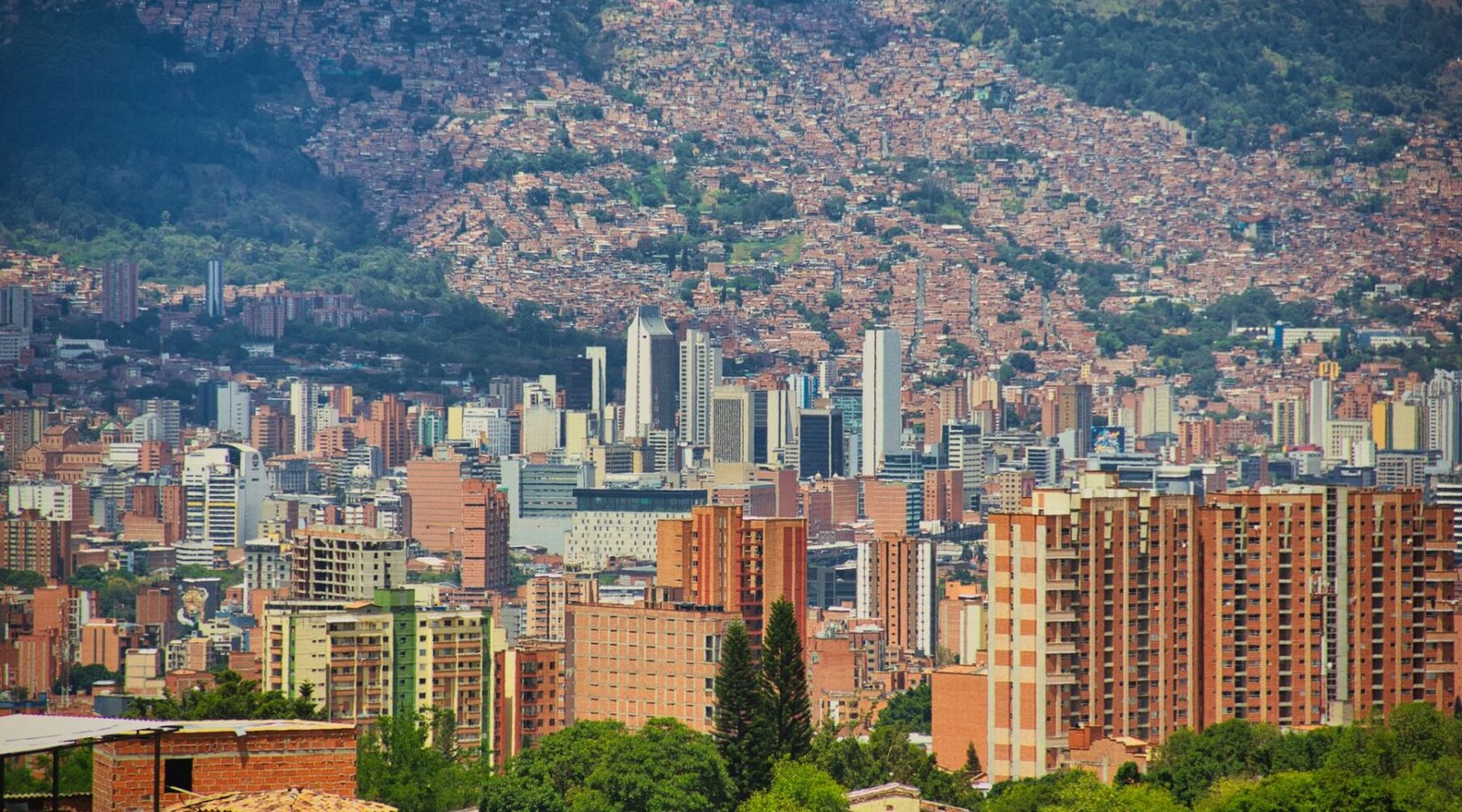 Aerial view of El Poblado high-rises against the green hills of the Aburrá Valley, Medellín