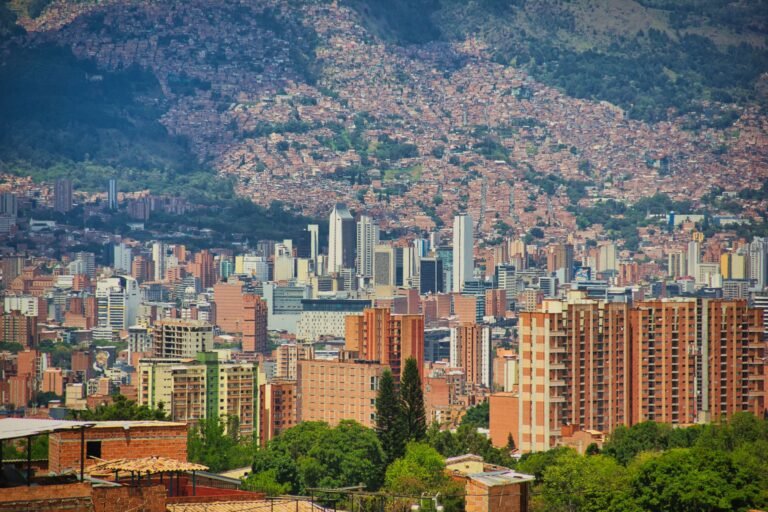 Aerial view of El Poblado high-rises against the green hills of the Aburrá Valley, Medellín