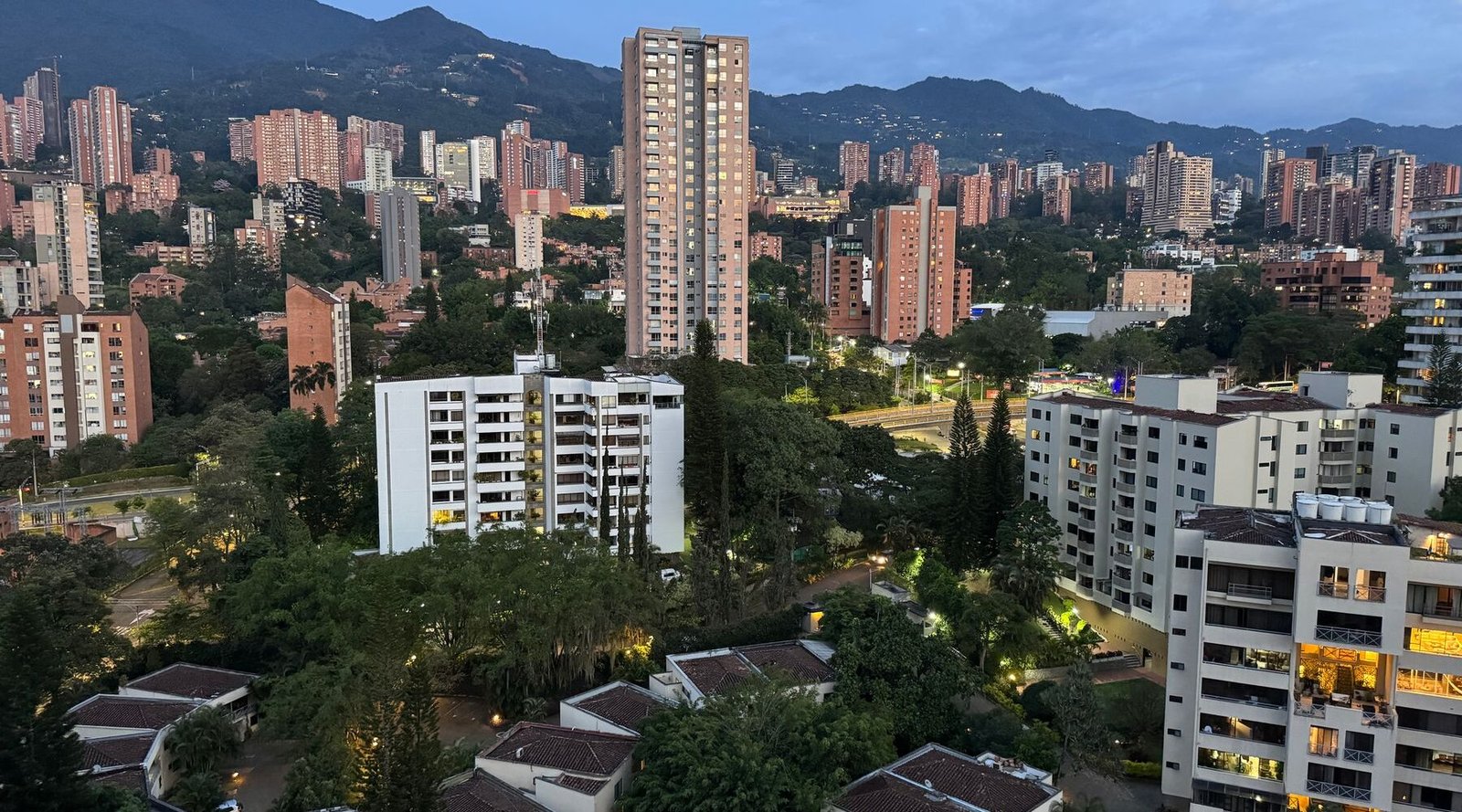 Daytime view over El Poblado, Medellín, with high-rises and forested hills behind