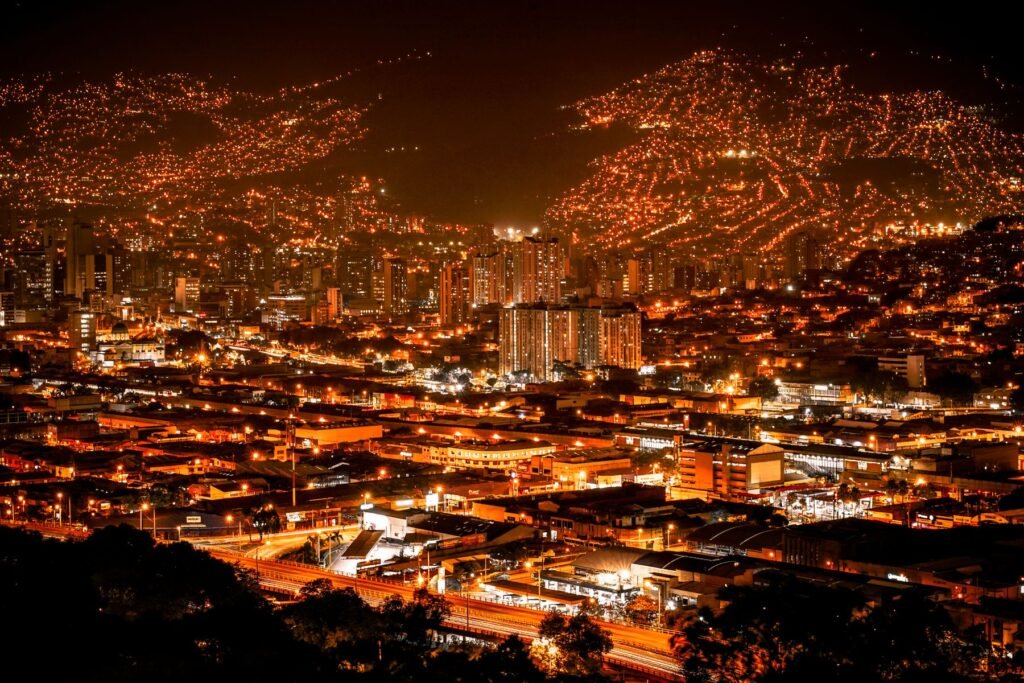 Medellín at night, the valley lit up in orange from the hillside