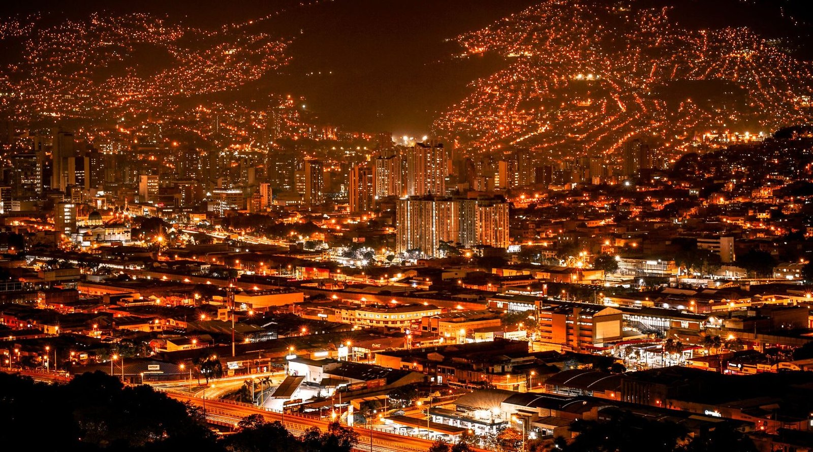 Medellín at night, the valley lit up in orange from the hillside