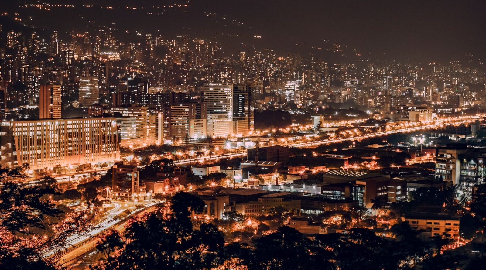 Medellín city lights at night across the valley
