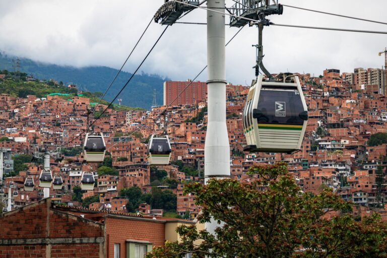 Metrocable gondolas over the terracotta rooftops of Medellín hillside neighbourhoods