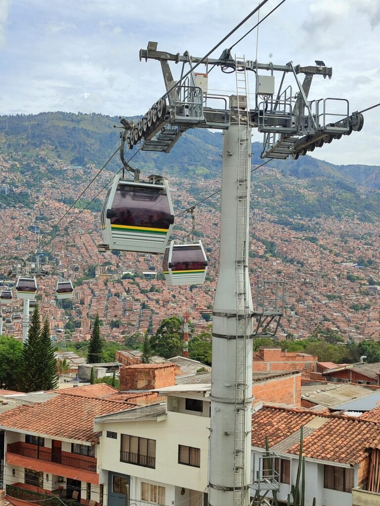 Metrocable gondolas gliding above the rooftops of Medellín