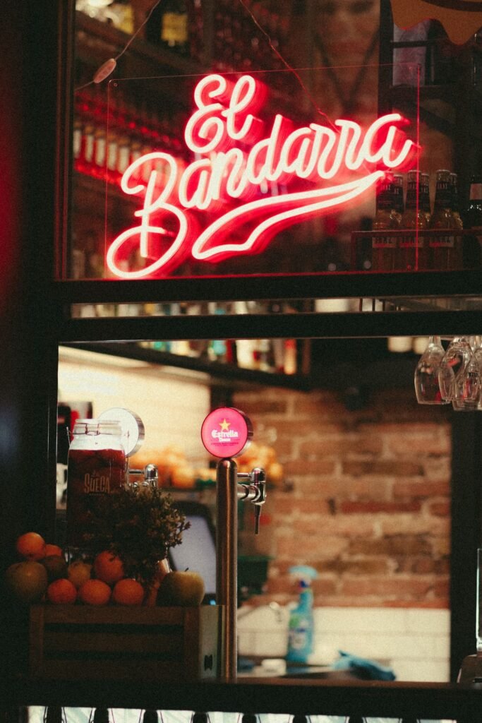 A neon-lit bar entrance at night in Medellín